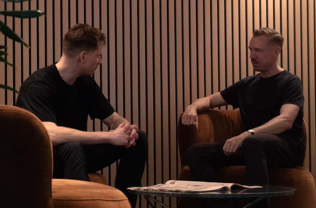A group of people discussing in front of a whiteboard